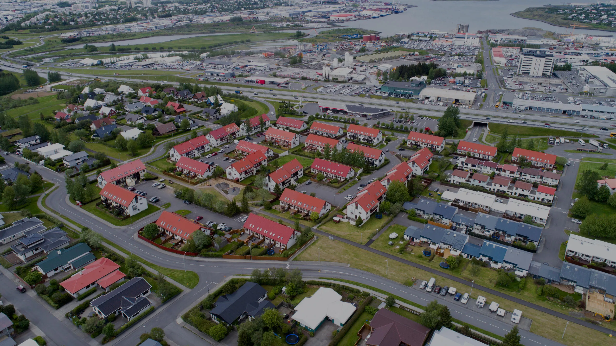 Aerial photograph of a Reykjavik residential neighbourhood by the sea.